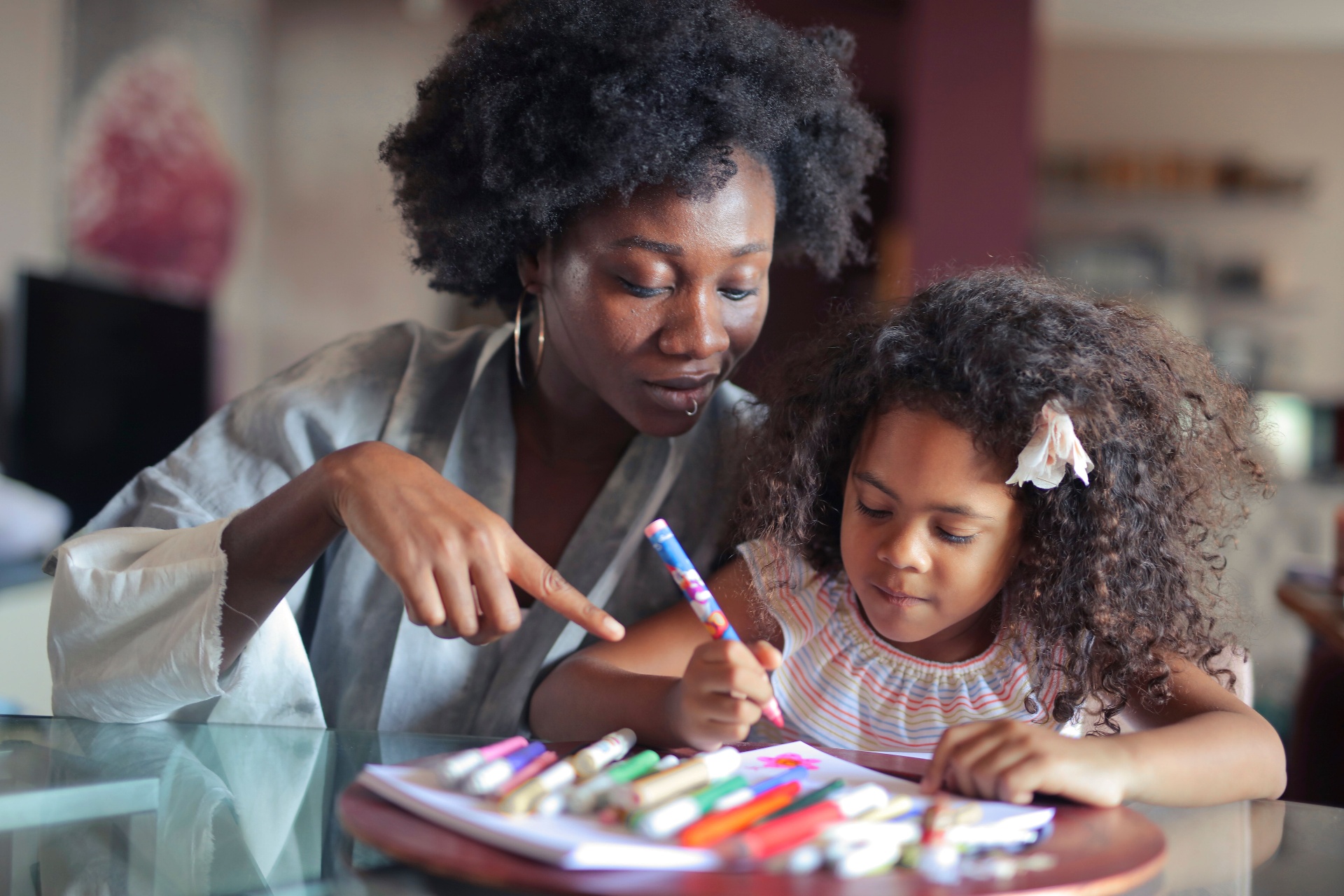 Christian mother reading Scripture with her children at home